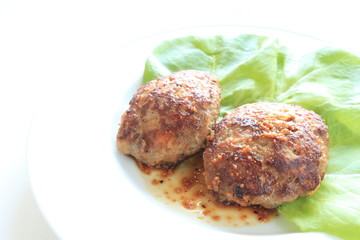 homemade hamburger steak with sauce on white dish