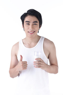 Young healthy man with a glass of milk in hand