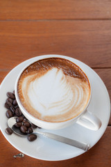 Cup of hot caffe latte with coffee grain