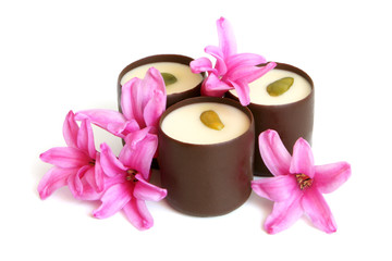Chocolate sweets with pink flowers of hyacinth