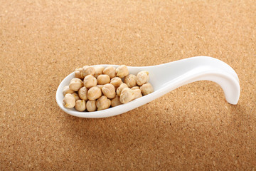 Porcelain spoon with seeds chickpeas