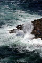 Water splashing over rocky outcrops in ocean at Esha Ness.