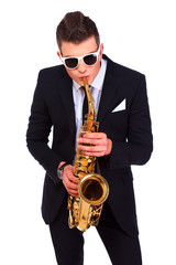 Fototapeta premium Saxophonist in a suit and modern sunglasses