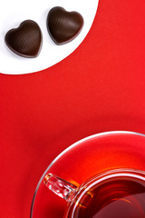 Tea cup and chocolate hearts