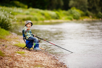 photo of little boy fishing