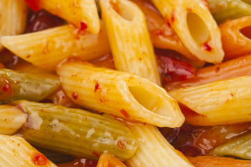 Penne rigate pasta with tomato sauce. background