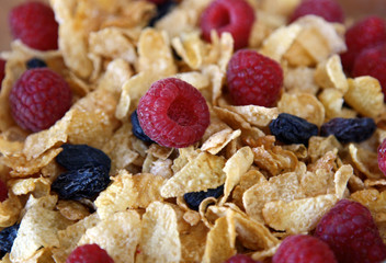 close-up background: flakes, ripe raspberries and raisins