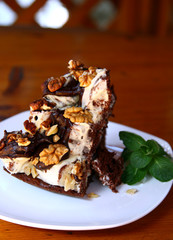 decorated chocolate pie with walnut on plate