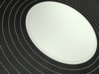 Black and white stitched circle shape on leather