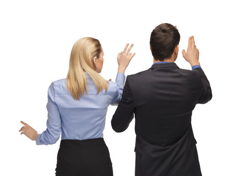 man and woman working with something imaginary