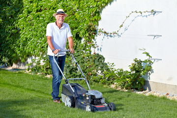 Senior man is cuting the grass 3