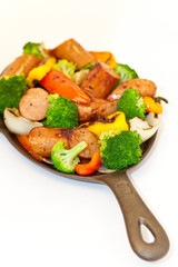 Grilled sausages, red bell peppers, onions and broccoli