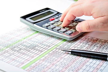 Tax forms, spread sheet with pen and calculator.