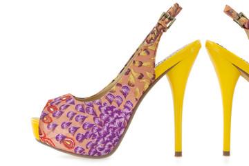 Yellow women stiletto shoes, isolated on white .