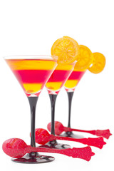 Yellow and red  fruit jelly with orange slice, with red spoons,