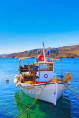Colorful side front view of wooden fishing boat at Santorini Isl
