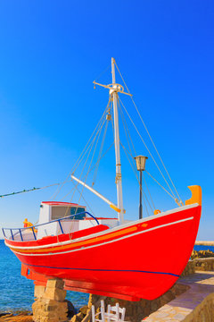 Famous red Boat side view in Mykonos Old Port, Greece Cyclades M
