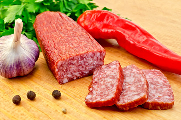Salami with vegetables on the board