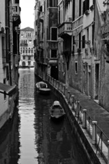 narrow canal and reflections black and white