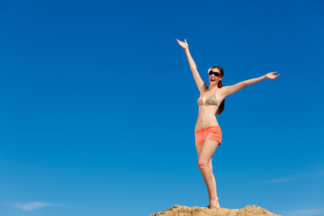 Fototapeta premium Portrait of young woman in bikini at beach
