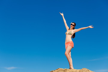 Fototapeta premium Portrait of young woman in bikini at beach