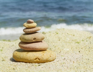 Fototapeta na wymiar spa stones on sea shore background