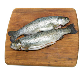 raw trout on a cutting board on a white background