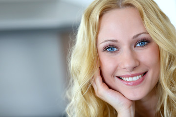 Portrait of smiling blond woman with curly hair