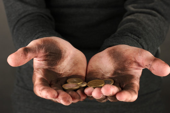homeless man holding a coins, close-up