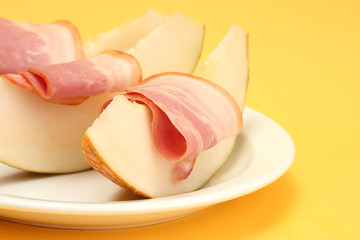 parma ham and melon, on yellow background