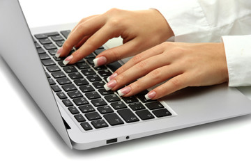 Fototapeta na wymiar female hands writing on laptot, close up