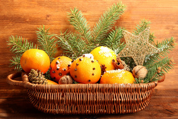 christmas composition in basket with oranges and fir tree,