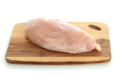 raw chicken meat on cutting board, isolated on white