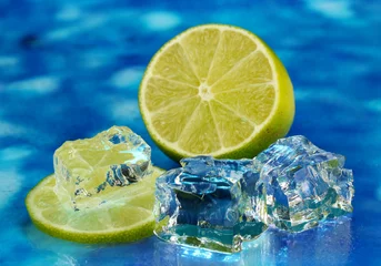 Foto auf Acrylglas Eiswürfel mit Limette auf blauem Hintergrund © Africa Studio