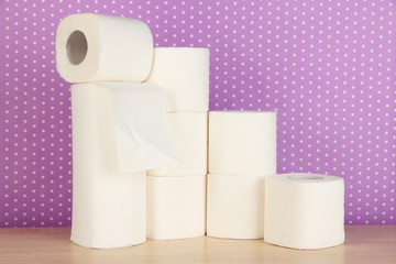 Rolls of toilet paper on purple with dots background