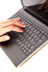 closeup finger typing on a laptop computer