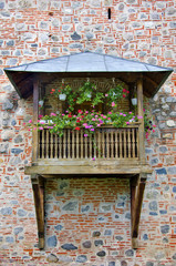 Fototapeta na wymiar wooden balcony decorated with pink and red flowers