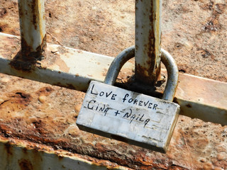 A padlock with caption "Love forever Gina+Naila" attached to the