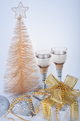 Champagne, gift box, snow, christmas toys and fir-tree