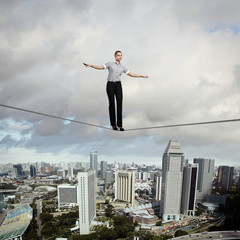 Balancing businesswoman and cityscape