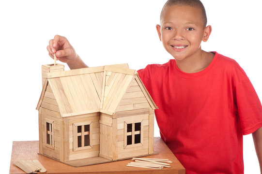 The house is made of toys from colorful popsicle sticks isolated