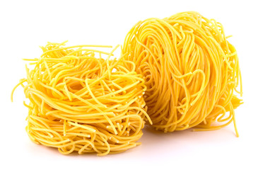 Italian pasta tagliatelle nest isolated on white background