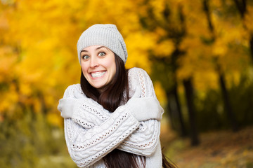 happy cheerful woman on a background of autumn trees