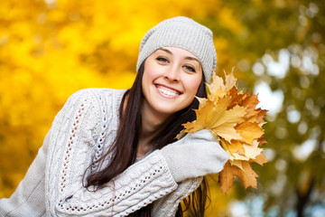 happy cheerful woman on a background of autumn trees