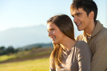 Fototapeta premium Close up portrait of couple outdoors at sunset.