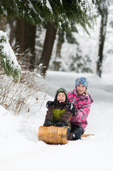 boy and girl tobogganing