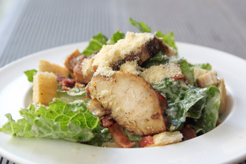 Chicken ceasar salad in a white plate