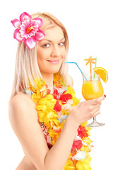Smiling woman dressed in a traditional costume drinking cocktail