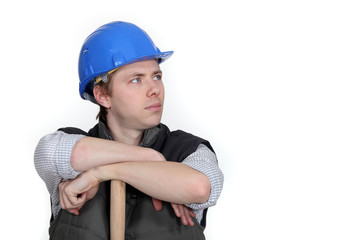 Worker resting on wooden stick