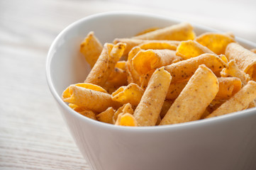 cheese potato chips in a white bowl